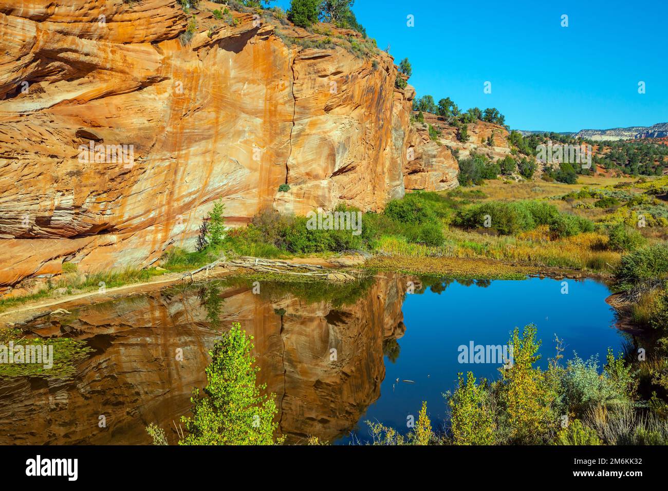 Small puddle reflects rocks and sky Stock Photo - Alamy