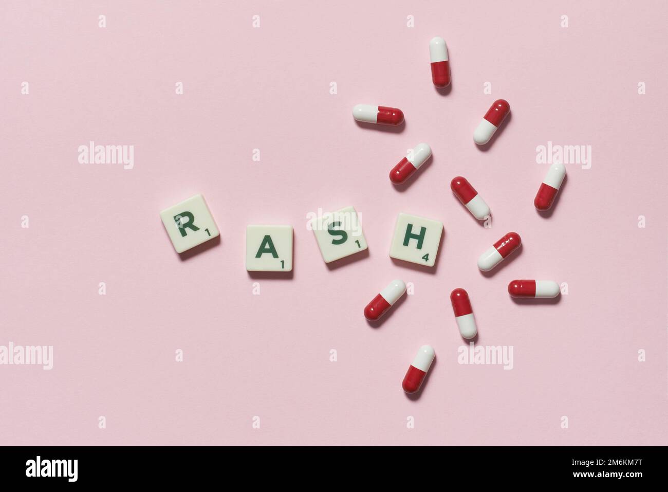 Rash formed of scrabble blocks and pharmaceutical pills. Stock Photo