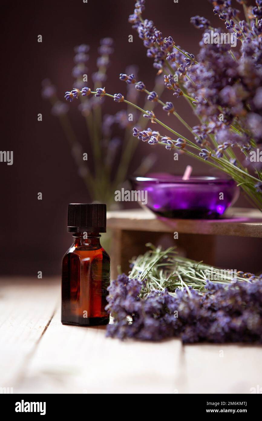 Herbal oil and lavender flowers on wooden background Stock Photo - Alamy