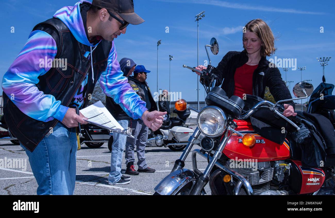 U.S. Army Capt. Rahan Dulamal, Joint Personal Effects Depot summary court martial officer, accomplishes safety checks on a motorcycle owned by Airman 1st Class Elizabeth Burnette, 436th Civil Engineer Squadron emergency management apprentice, during the 2022 Motorcycle Safety Day mentorship ride on Dover Air Force Base, Delaware, April 29, 2022. Hosted by the 436th Airlift Wing Safety Office, “The Message of Mentorship” was this year’s theme as Burnette and other riders participated in a planned ride throughout central Delaware. Stock Photo
