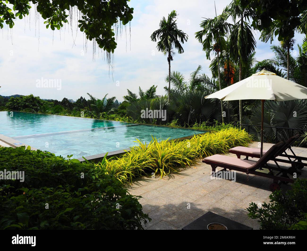 Infinity Pool with view in Jungle & Ocean, Wellness South East Asia #Asia #Vietnam #PhuQuoc #aroundtheworld #SouthEastAsia #hinterland #authentic Stock Photo