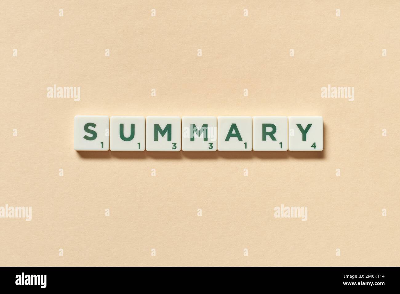 Summary formed of scrabble tiles on beige background. Stock Photo
