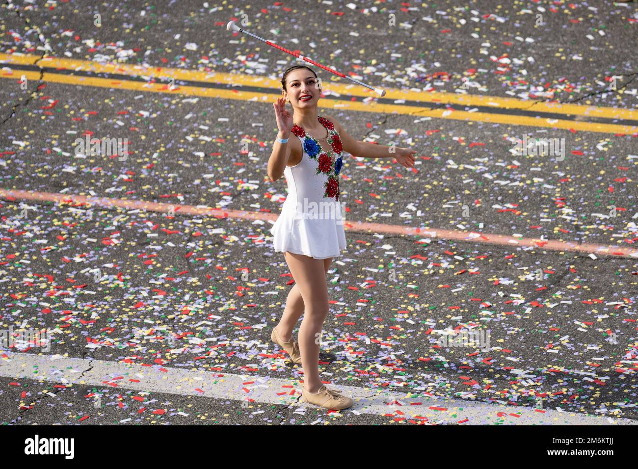 A twirler throws a baton in the 134th annual Rose Parade. Spectators