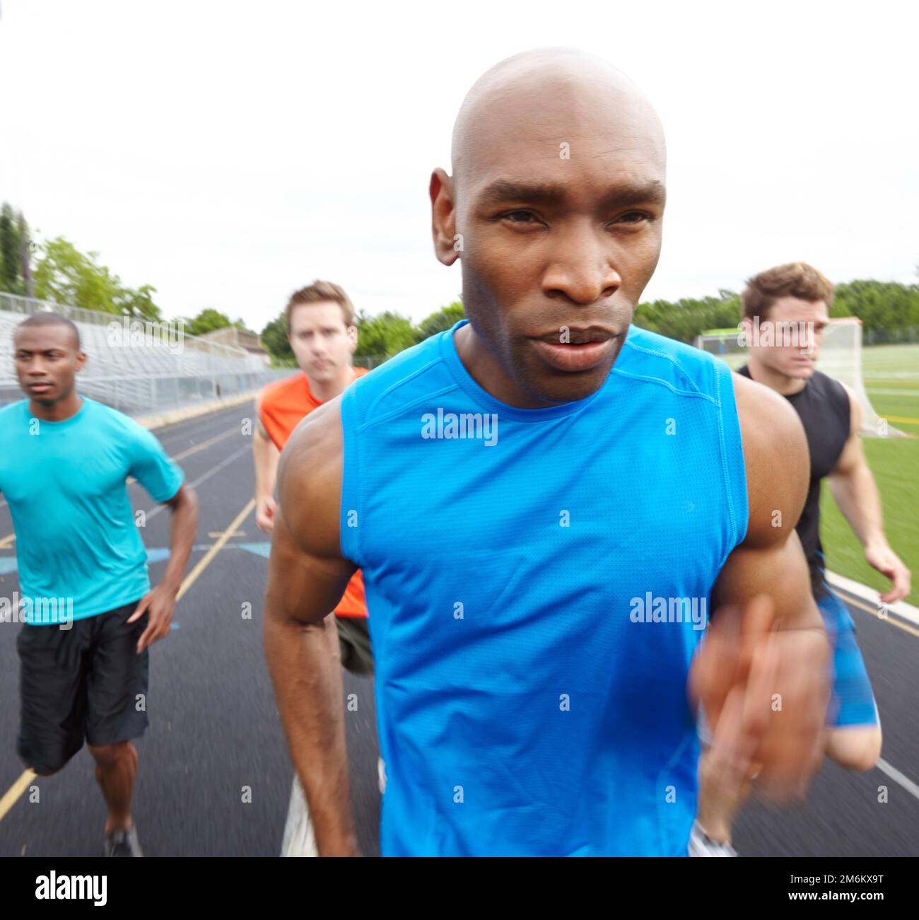 Ahead of the pack. Cropped front view of a focused male athlete with