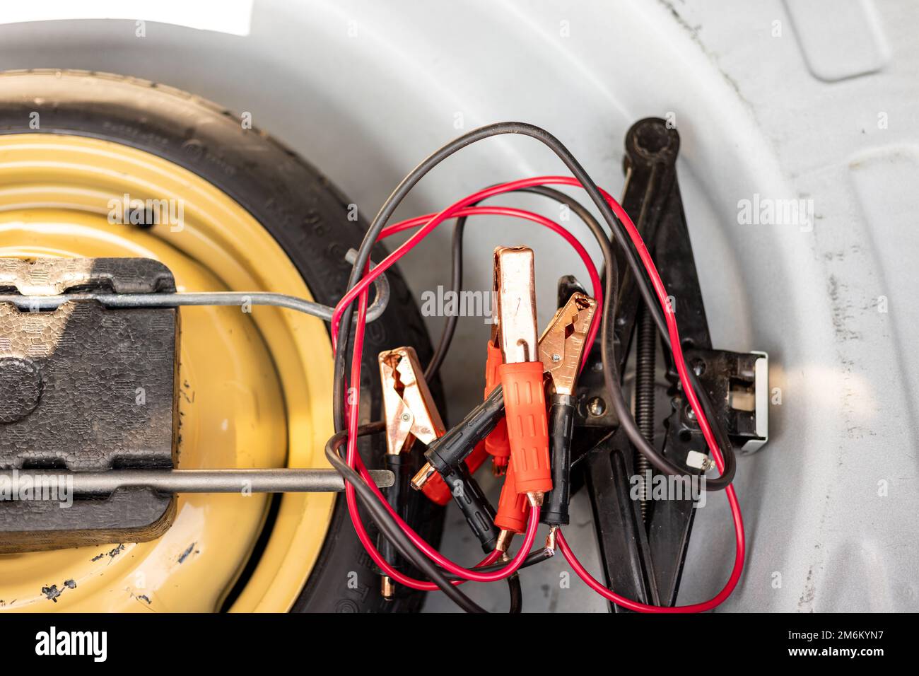 Jump start cable and car jack with wheel changing tools in car boot