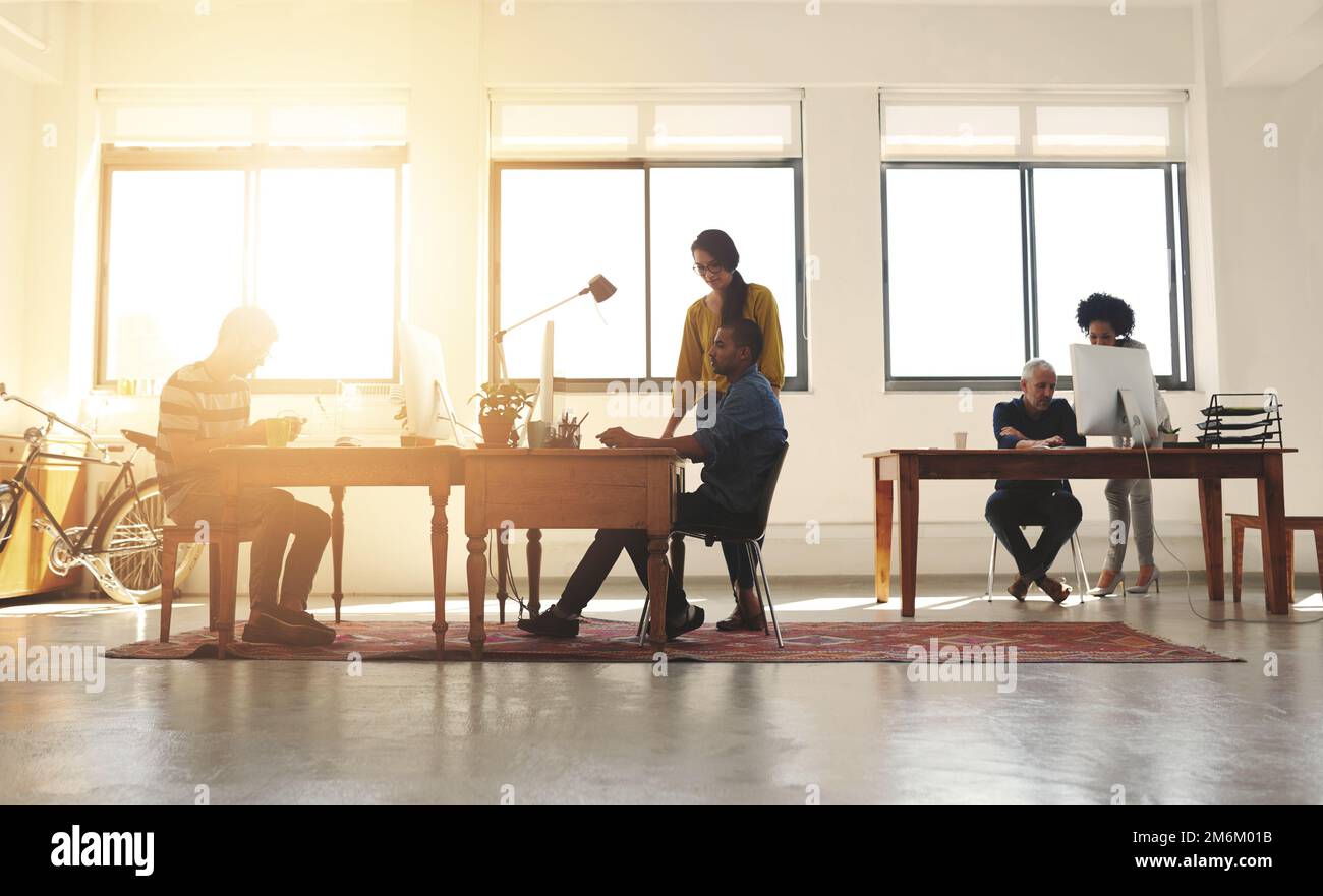 Creativity thrives in this office. a group of designers working in a modern office. Stock Photo