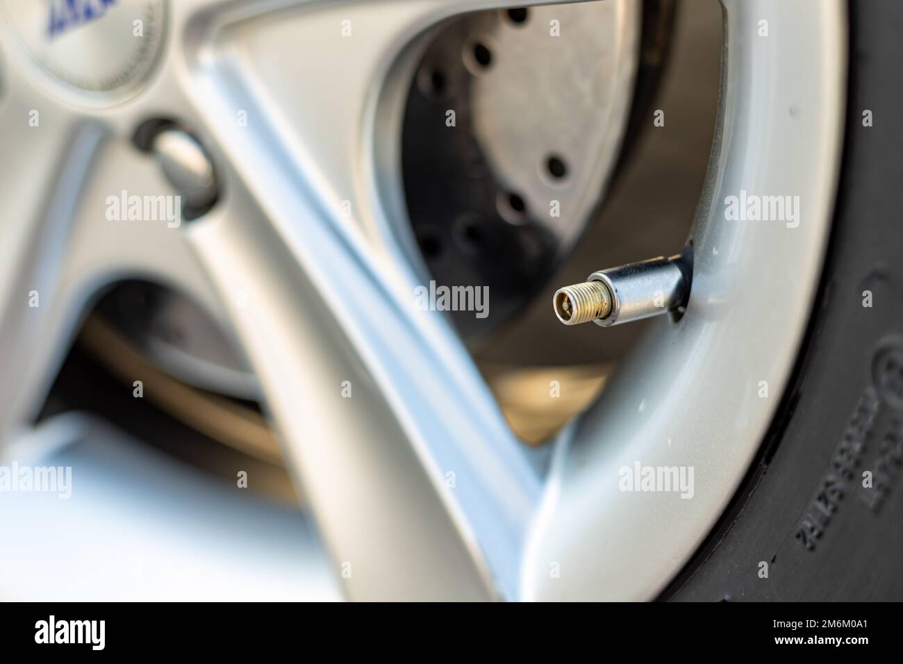 Air valve in a car tyre close-up Stock Photo