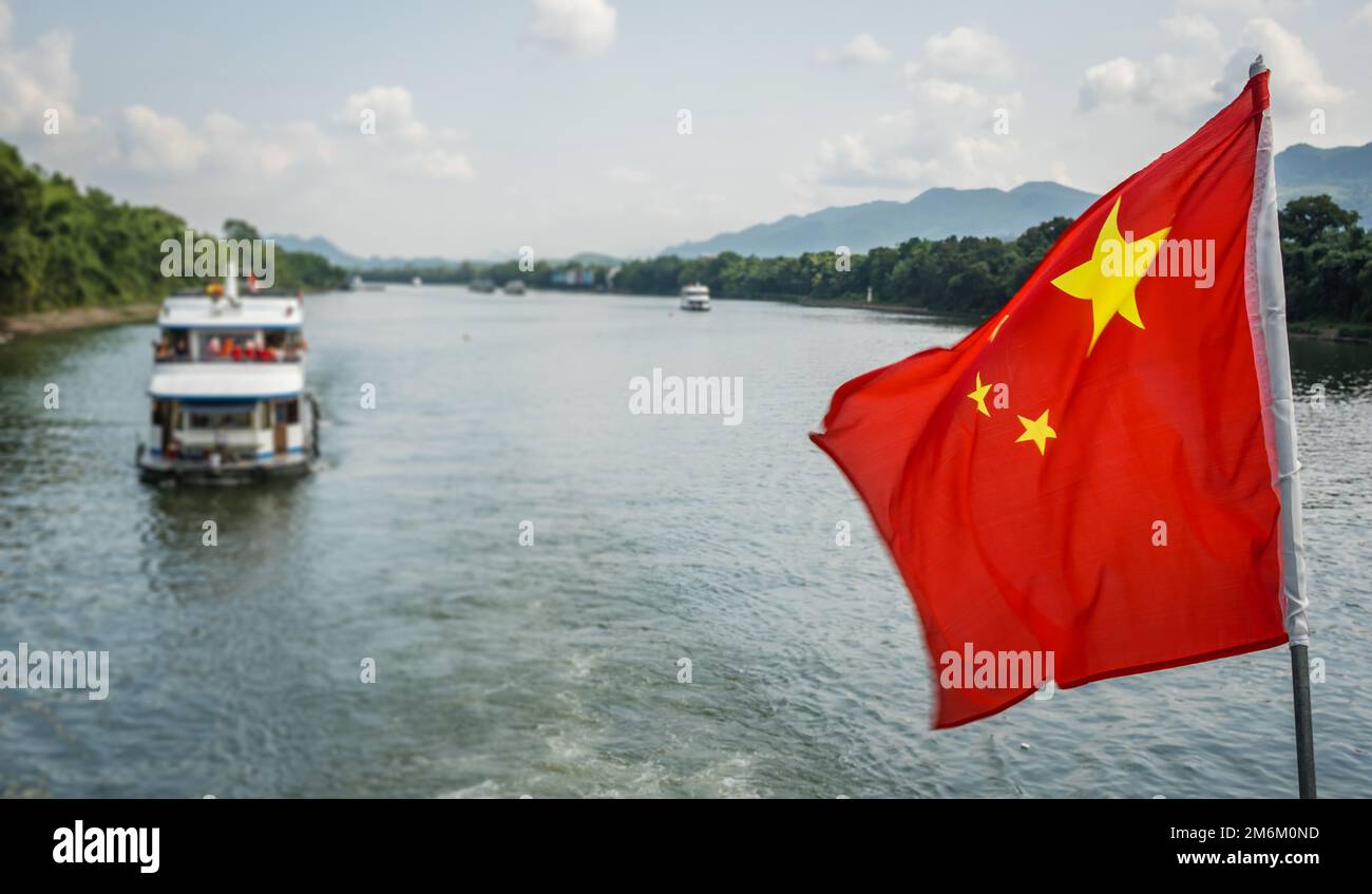 Red Chinese national flag on a boat sailing on Li River Stock Photo - Alamy