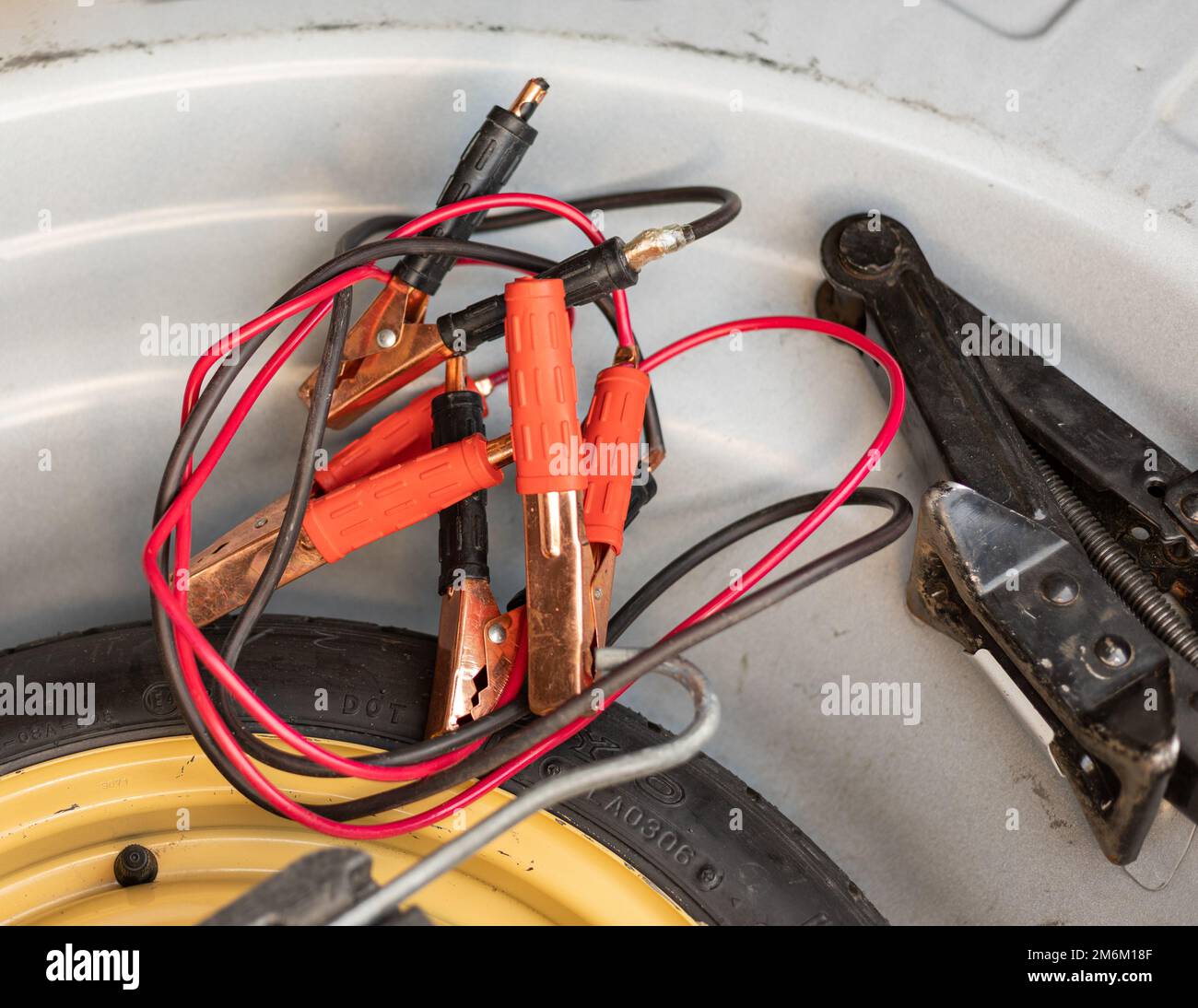 Jump start cable kit with jack in car trunk Stock Photo Alamy