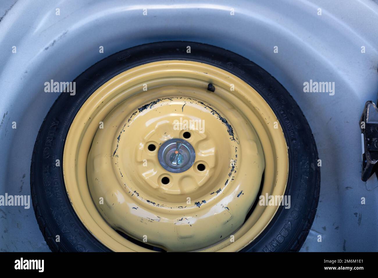 Stepney or donut tyre in a car boot space for temporary use Stock Photo