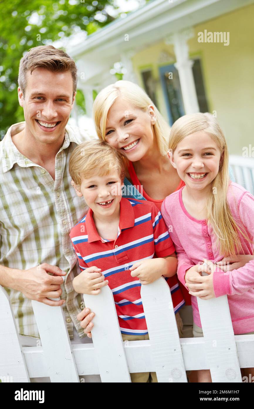 As close as family can be. a young family of four outside. Stock Photo