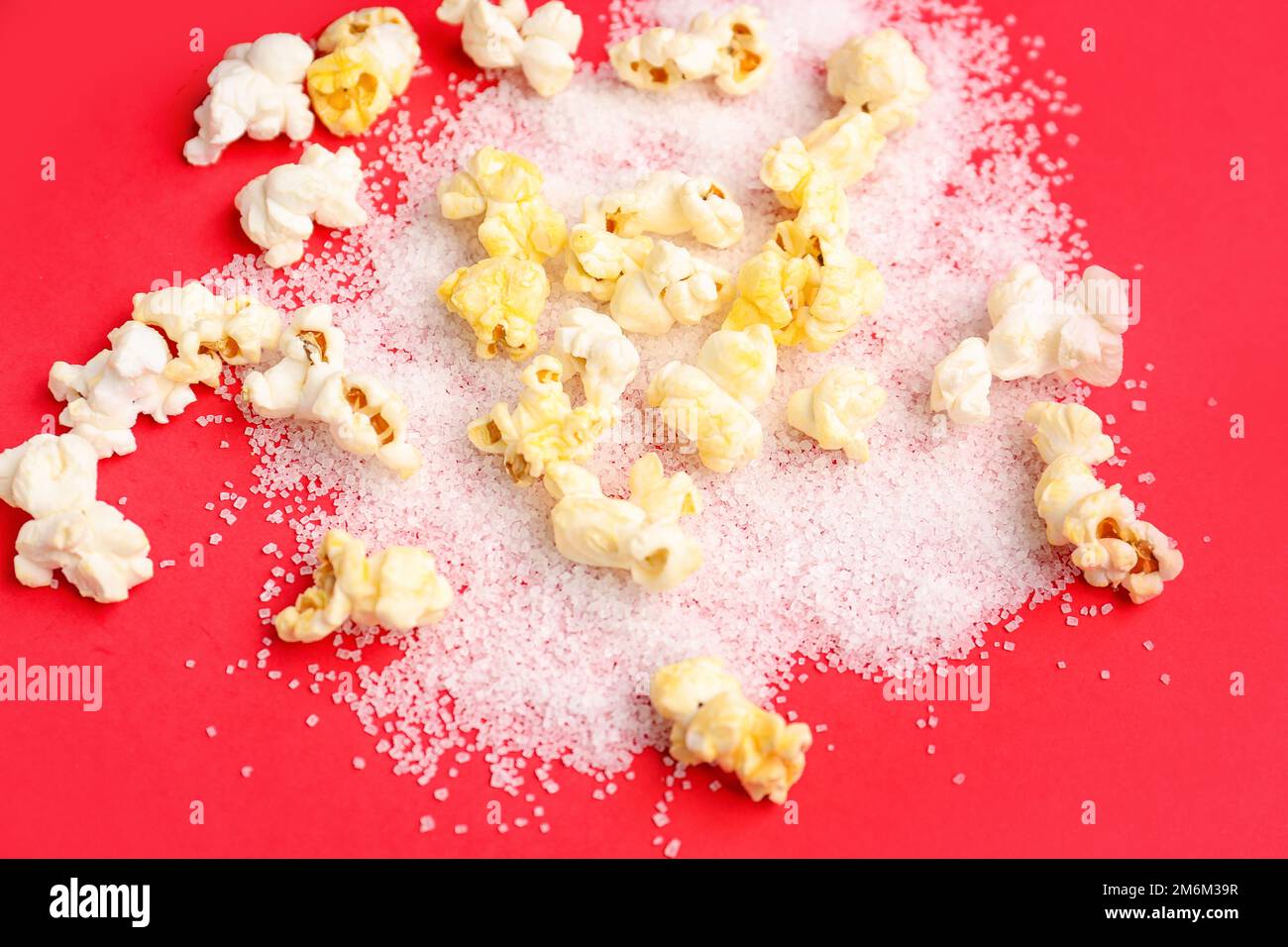 Tasty popcorn with sugar on red background Stock Photo Alamy