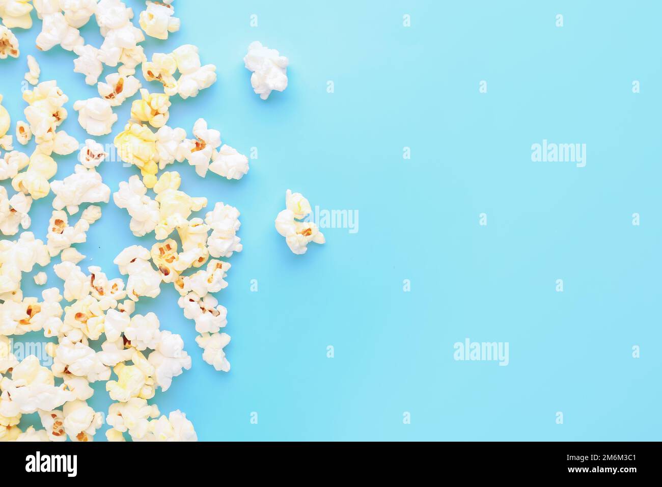 Scattered popcorn on color background Stock Photo