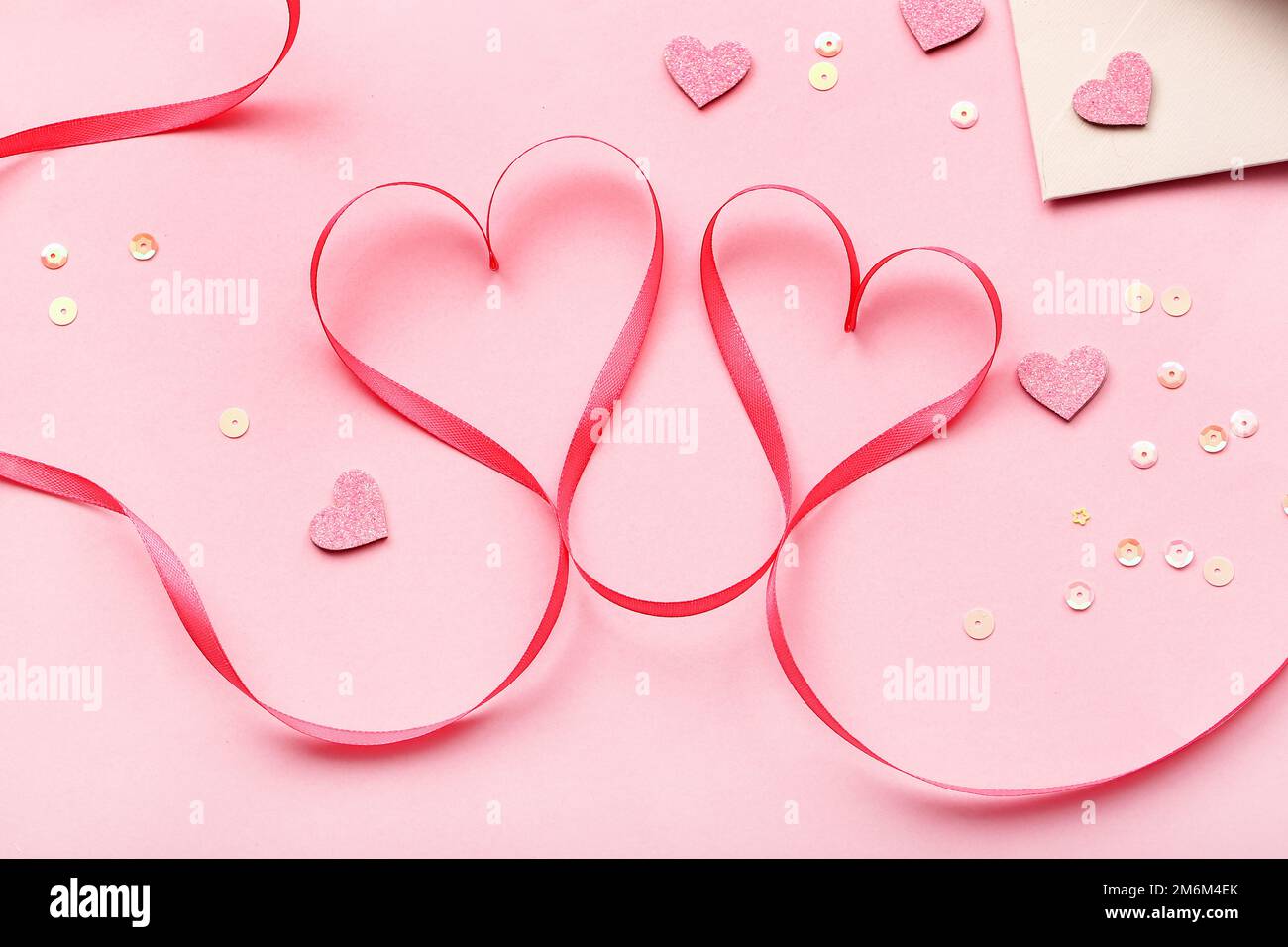 Ribbon with hearts and sequins on pink background. Valentine's Day ...