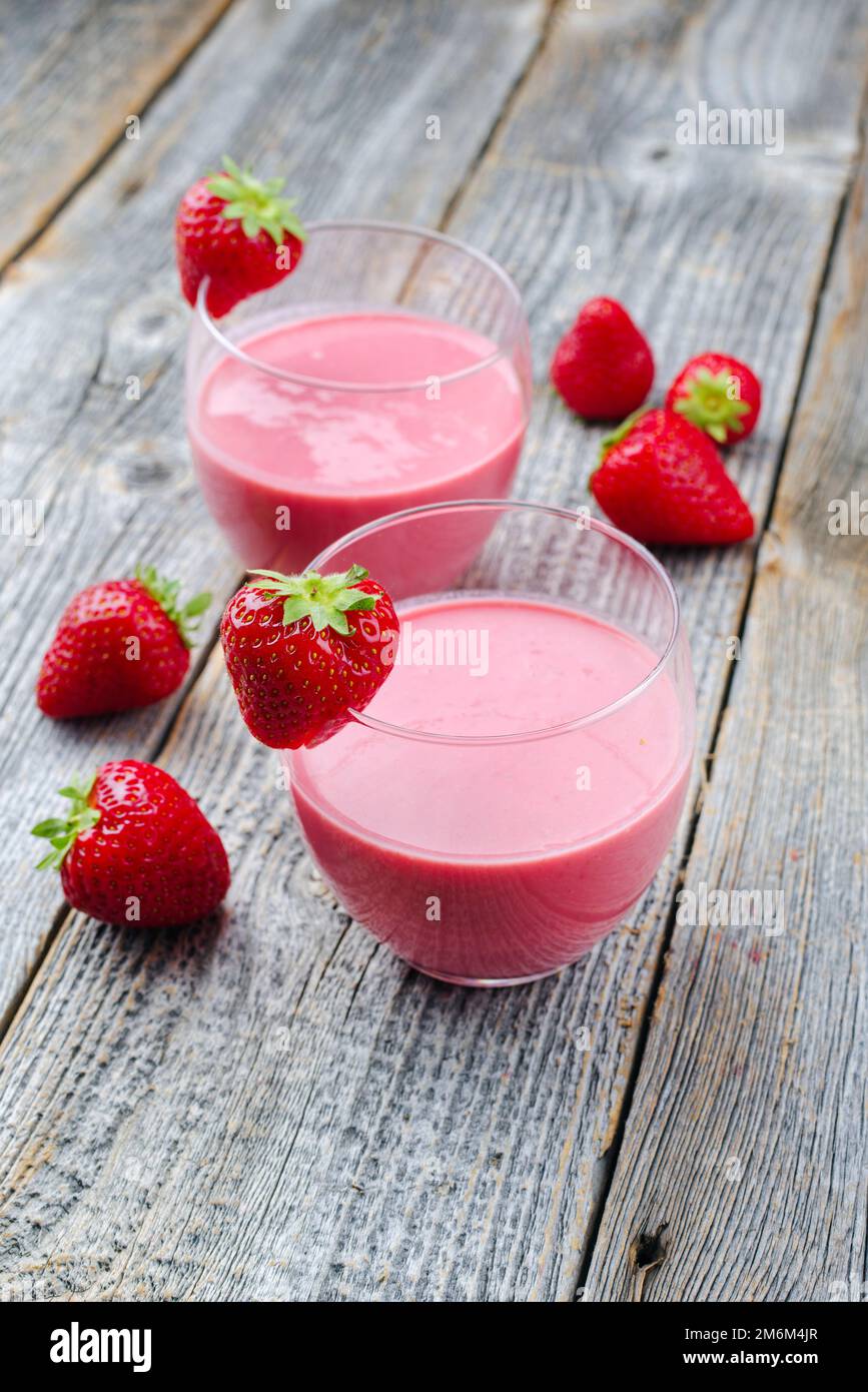 Traditional German strawberry with homemade strawberry curd served as closeup glass on a wooden