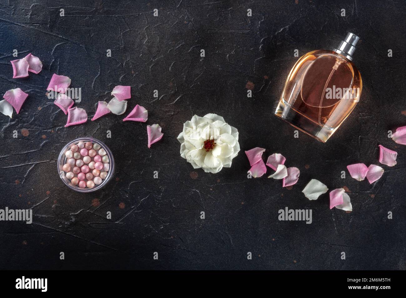 Beauty and cosmetics concept. A bottle of perfume and makeup, overhead Stock Photo
