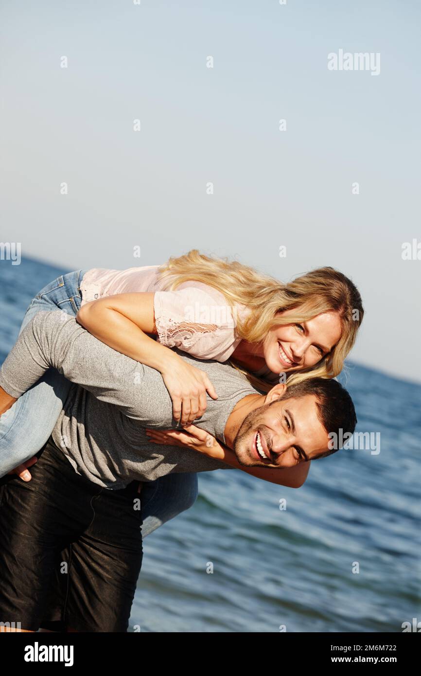 Love makes everything possible. Handsome young man giving his girlfriend a  piggyback ride while spending time together 13571900 Stock Photo at Vecteezy