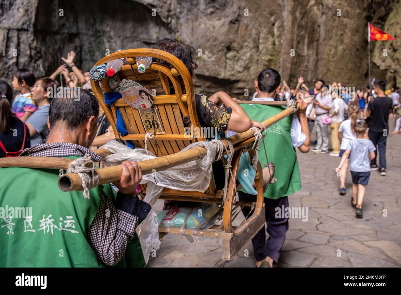 Tourists carried in a litter in Wulong National Park Stock Photo