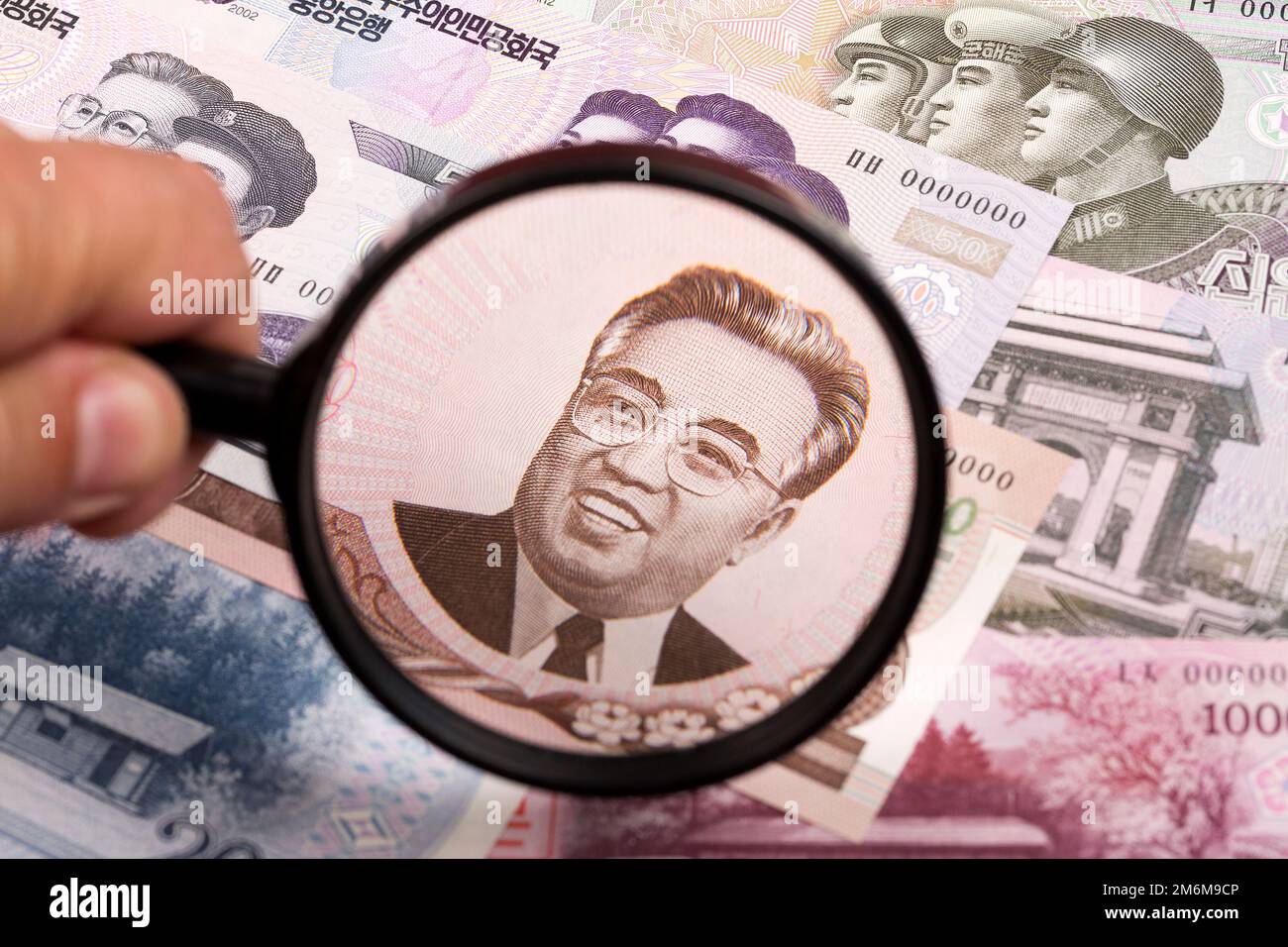 North Koreans money in a magnifying glass a business background Stock Photo