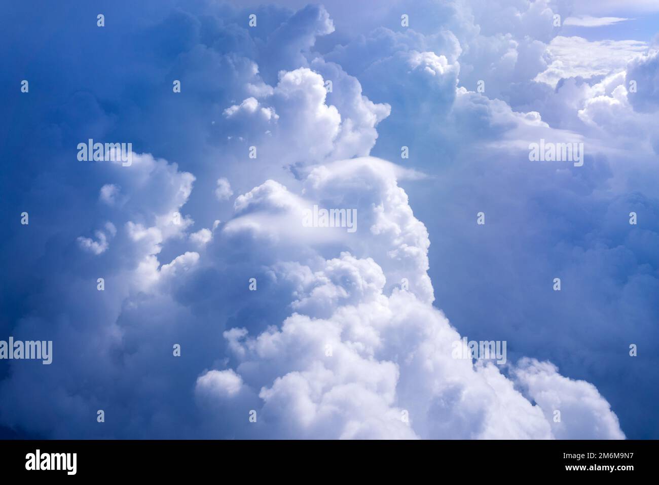 White cloud on blue sky. See through the plane window in sunny weather ...