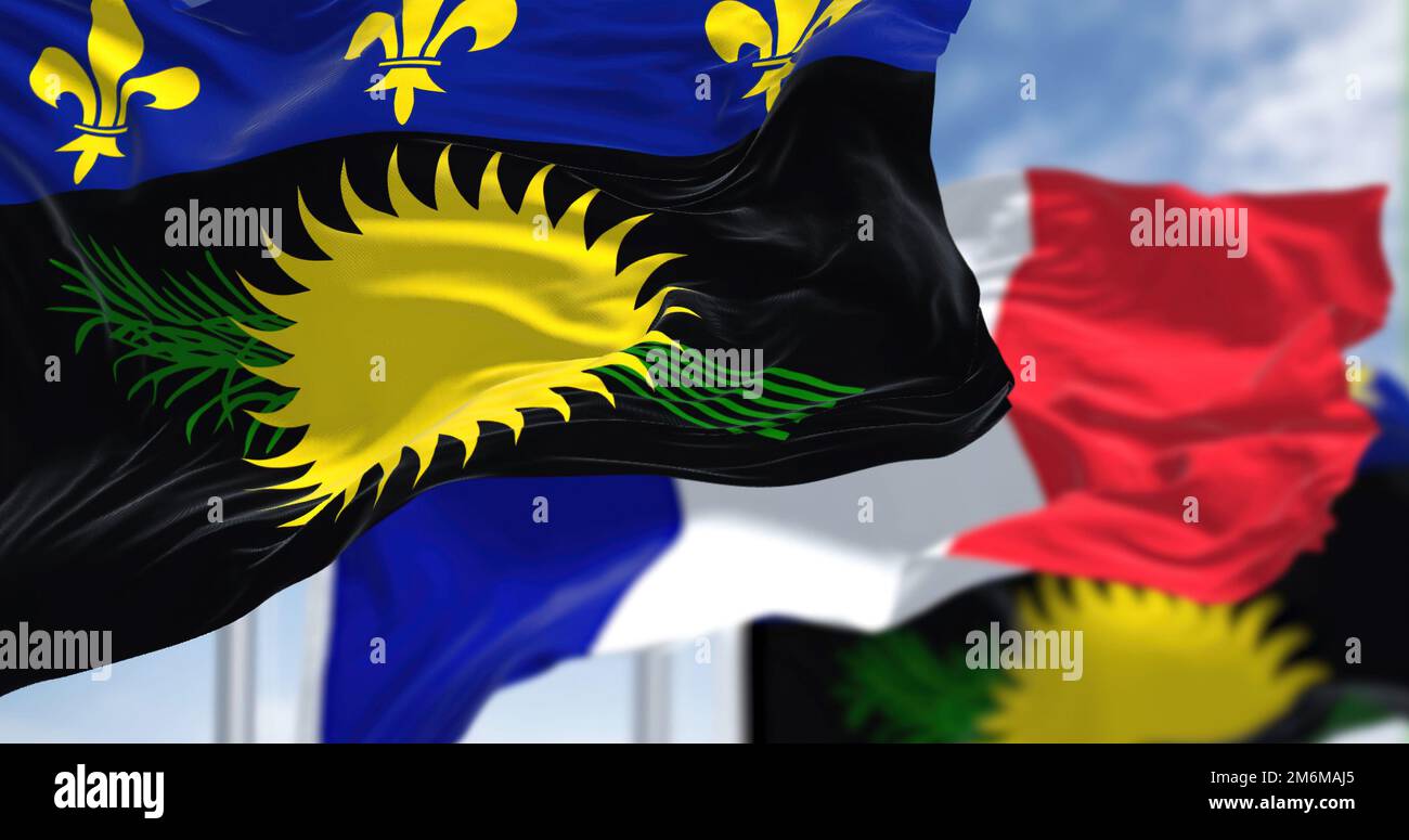 National flags of Guadeloupe waving the with the flag of France on a