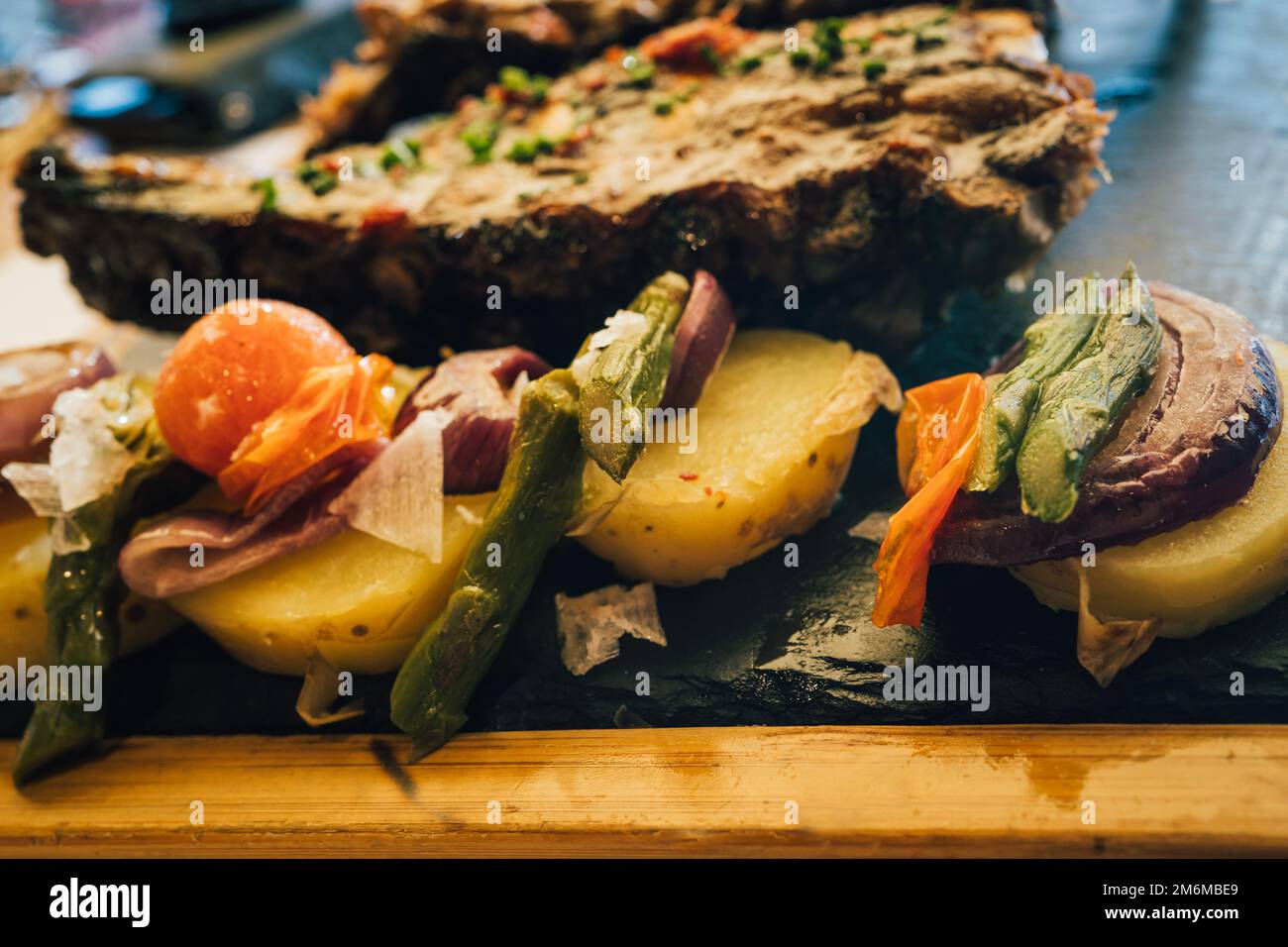 Close up view of side dish vegetables and roast potatoes. Glazed honey