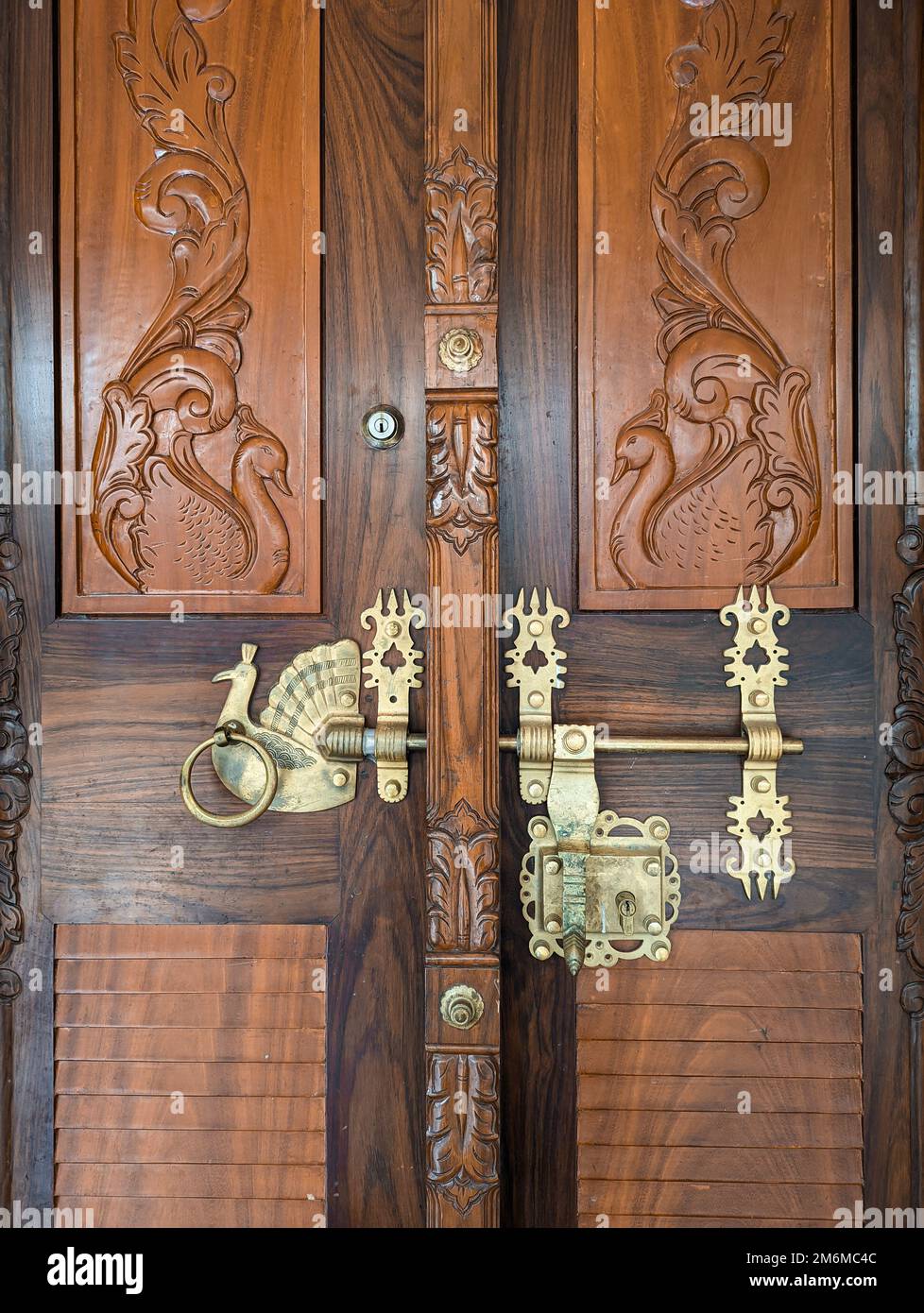 a highly detailed handcrafted golden door handle and lock on a vintage