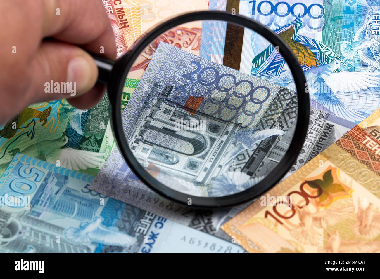 Kazakhstani tenge in a magnifying glass a business background Stock Photo