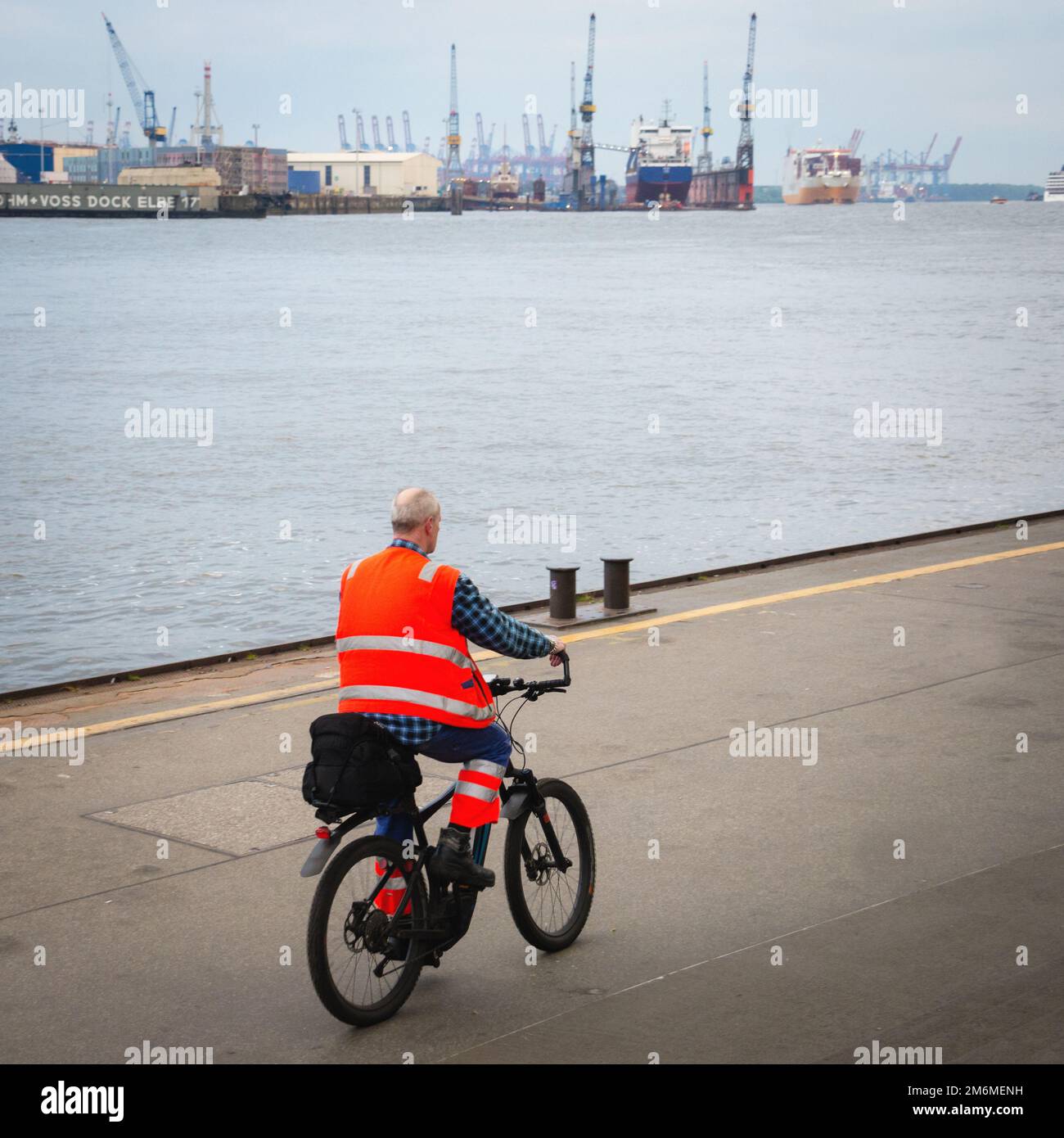 Male worker with reflective jacket at commercial dock Stock Photo