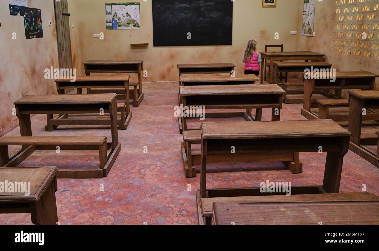 Empty ordinary classroom in African school poor conditions wooden table chairs Stock Photo Alamy