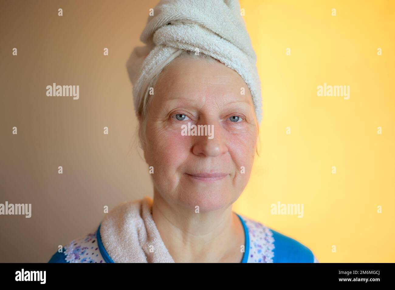 Aged woman with wet hair after bath. Stock Photo
