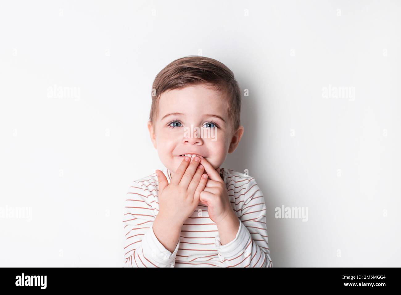 Beautiful invitation with happy toddler boy laugh. Healthy lifestyle. Kid life. Smiling happy child on white background Stock Photo