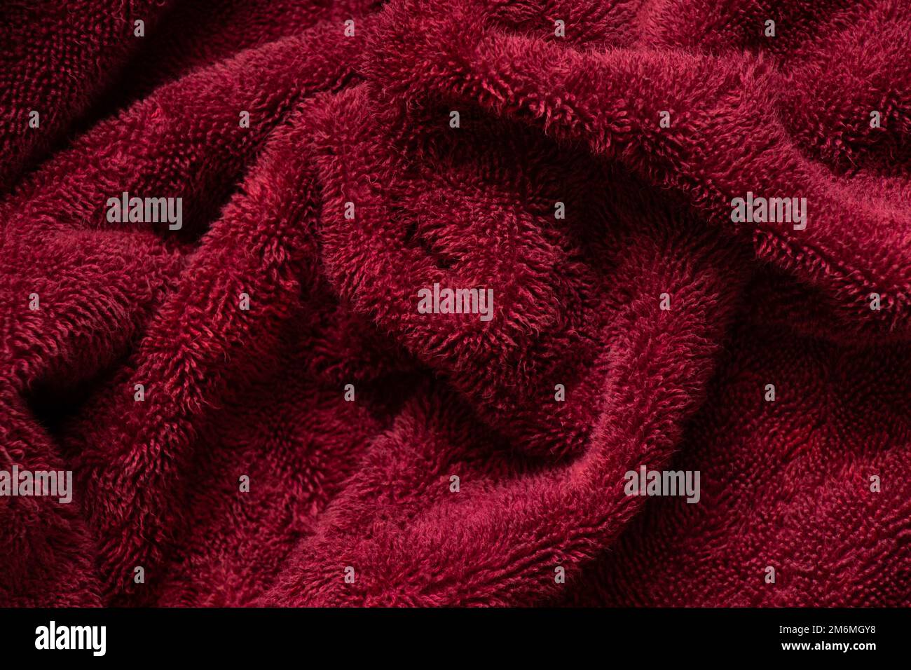 large red towel crumpled as a background close up Stock Photo