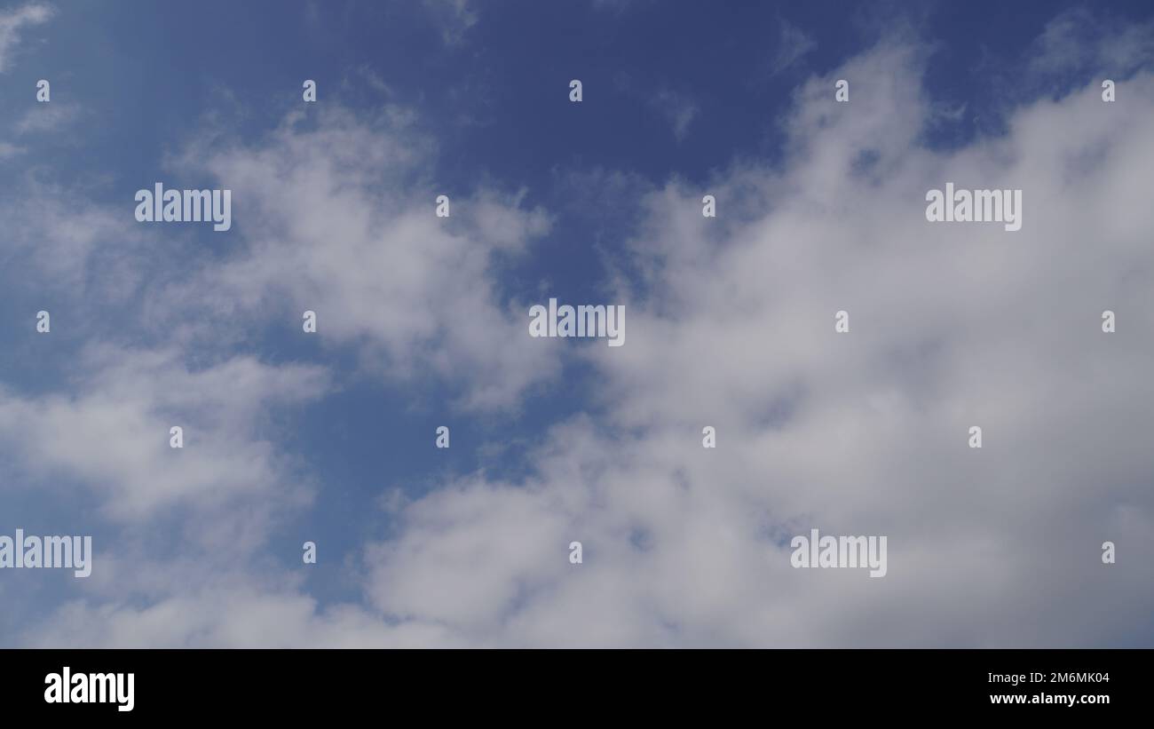 Blue sky with puffy white clouds Stock Photo - Alamy