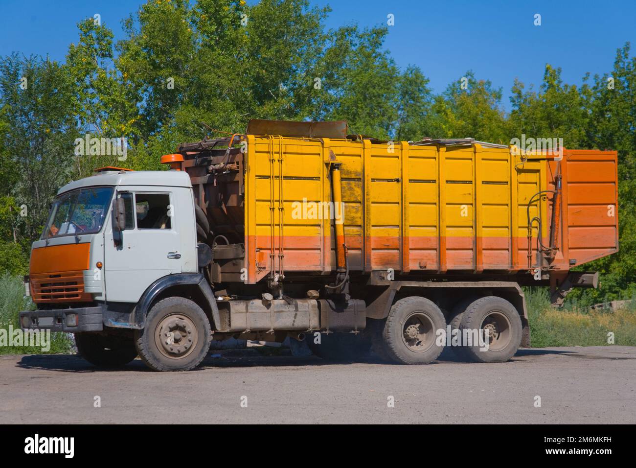 Heavy yellow garbage truck KAMAZ Stock Photo Alamy