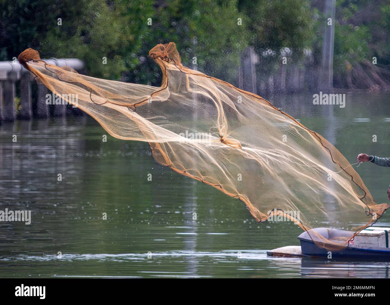 The net that was thrown out Hoping to catch fish in the canal Stock Photo
