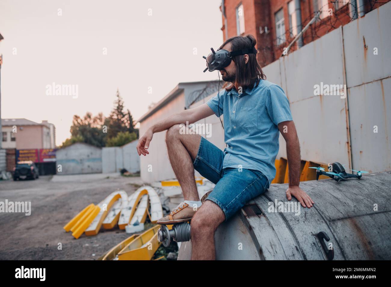 Man pilot controlling quadcopter drone with remote controller pad Stock Photo