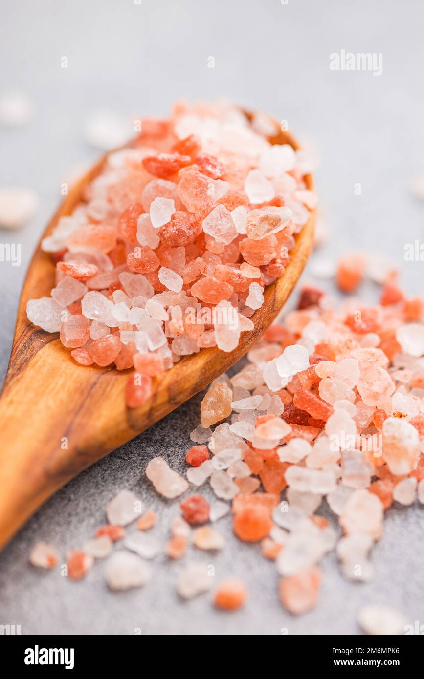 Pink himalayan salt in the wooden spoon. Stock Photo