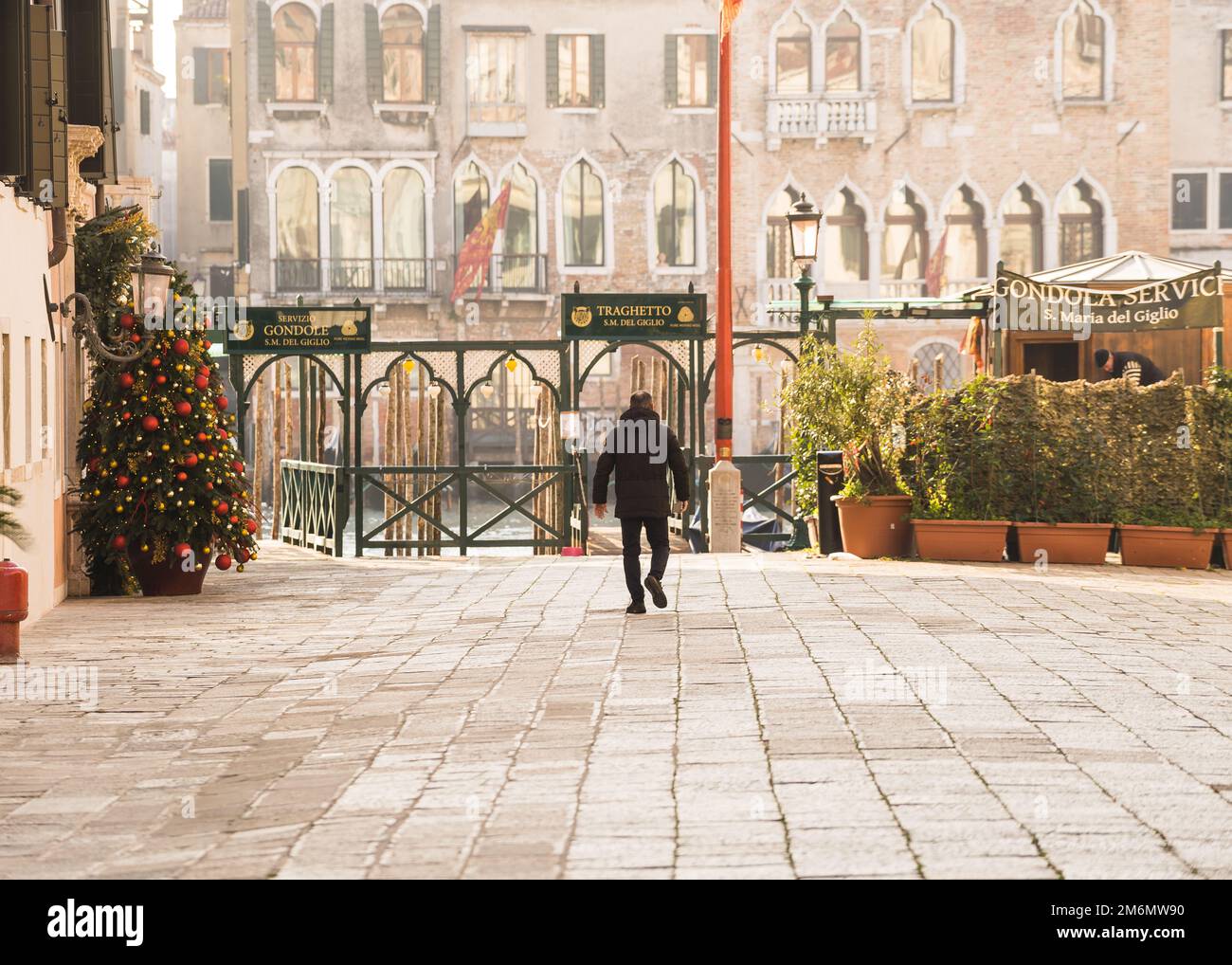 Gondolier walking towards gondola station in Venice, Italy Stock Photo