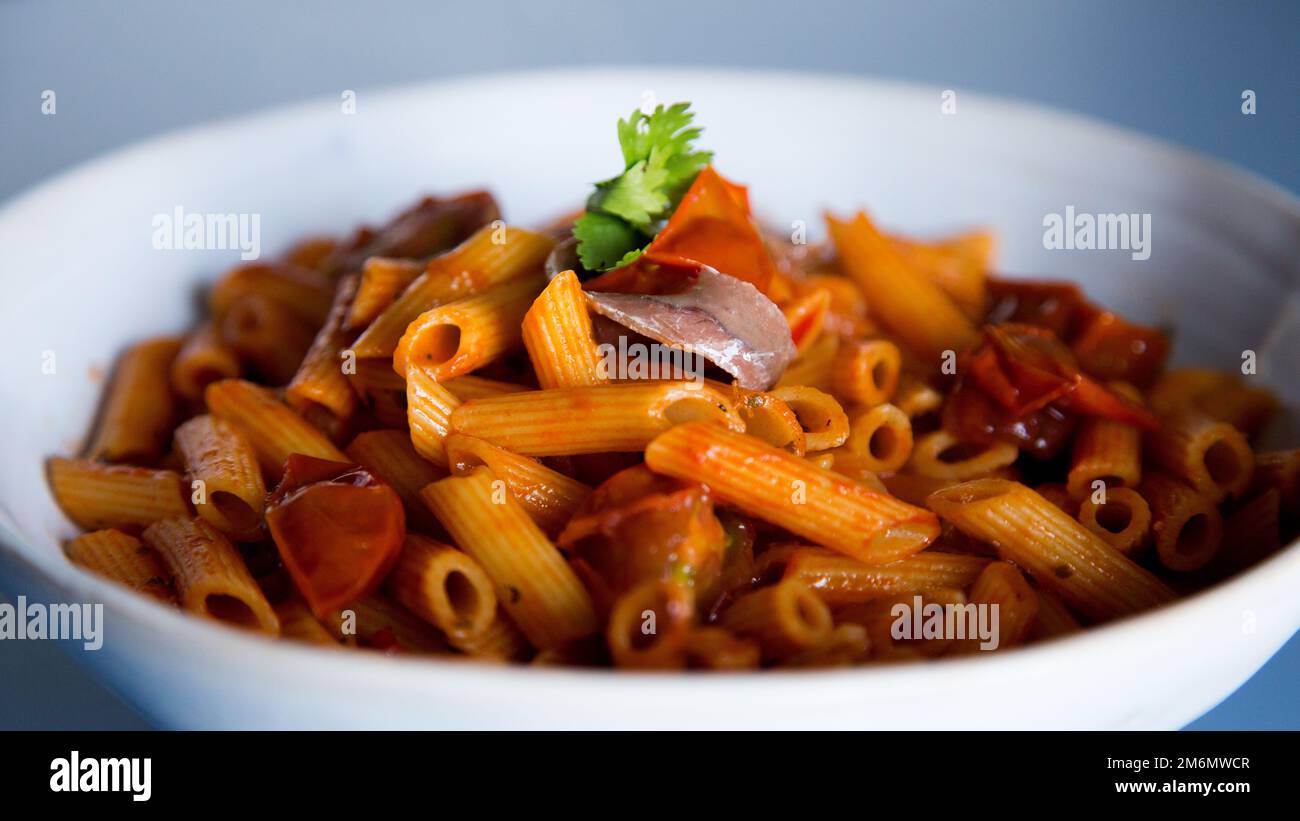 Pasta alla siciliana with anchovies. Pasta with tomato sauce, basil and