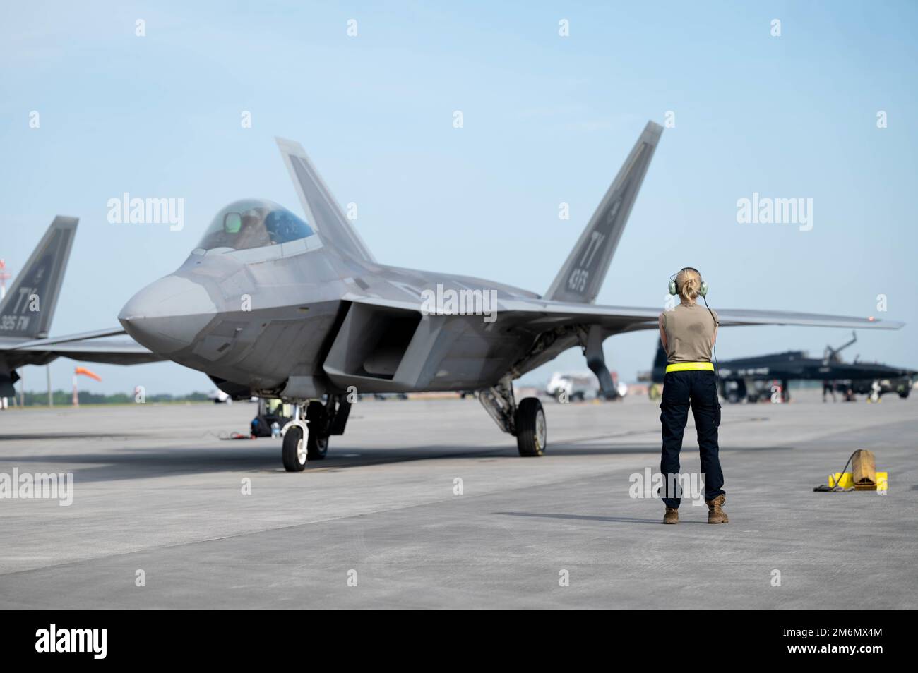 U.S. Air Force Airman 1st Class Megan Siver, 43d Fighter Generation Squadron assistant dedicated crew chief, prepares to launch out an F-22 Raptor at Savannah Hilton Head International Airport, Georgia, May 2, 2022. The 325th Fighter Wing sent more than 200 personnel and 22 aircraft to participate in Sentry Savannah, a near-peer training exercise hosted by the Air National Guard’s Air Dominance Center. Stock Photo