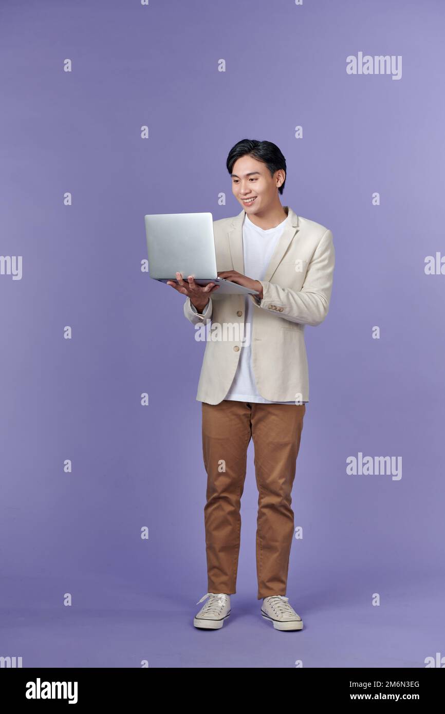 Young Asian business man using laptop computer Stock Photo