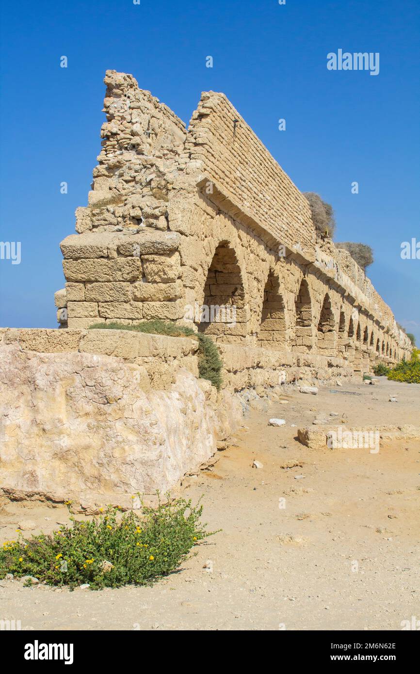 2 Nov 2022 A section of the magnificent ancient Roman aquaduct, where it crosses the Mediterranean beach at Ceaserea Maritima in Israel Stock Photo