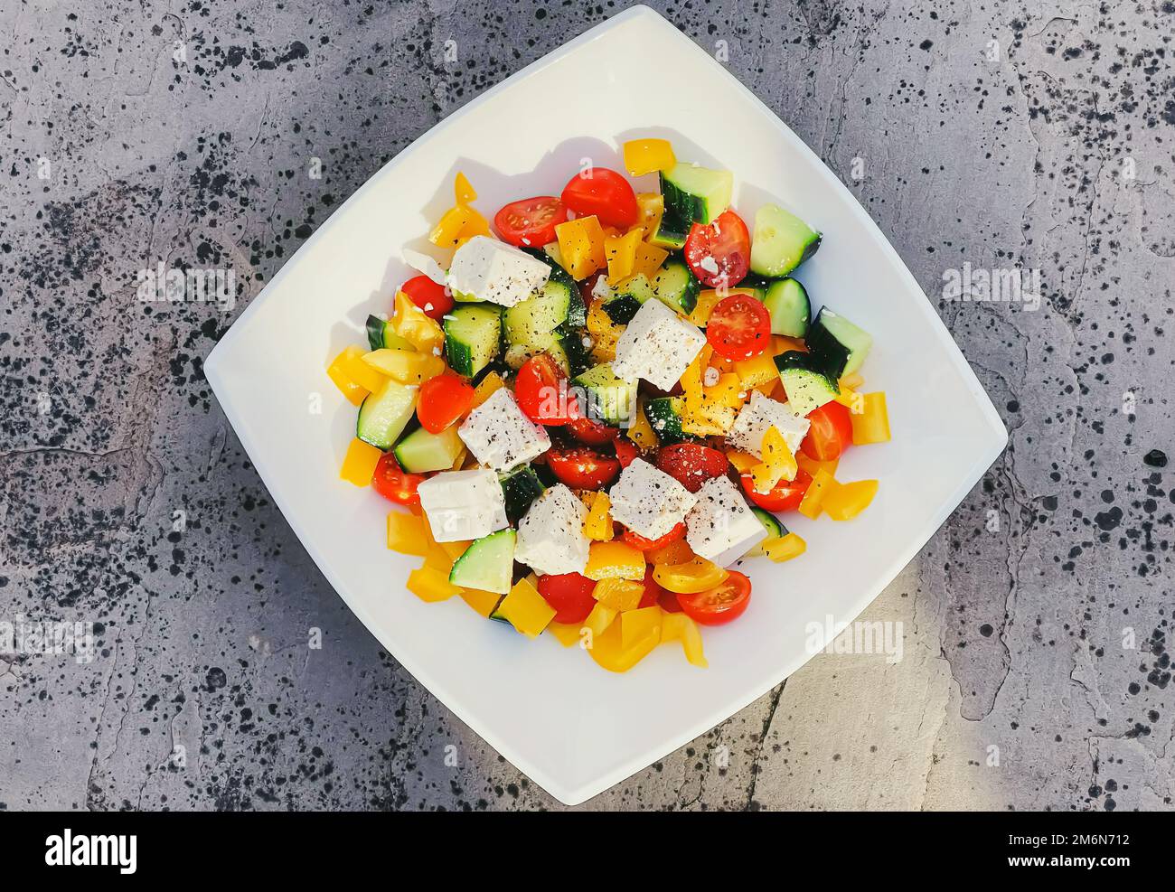 Fresh vegetable greek salad with cherry tomatoes, bell pepper, cucumber