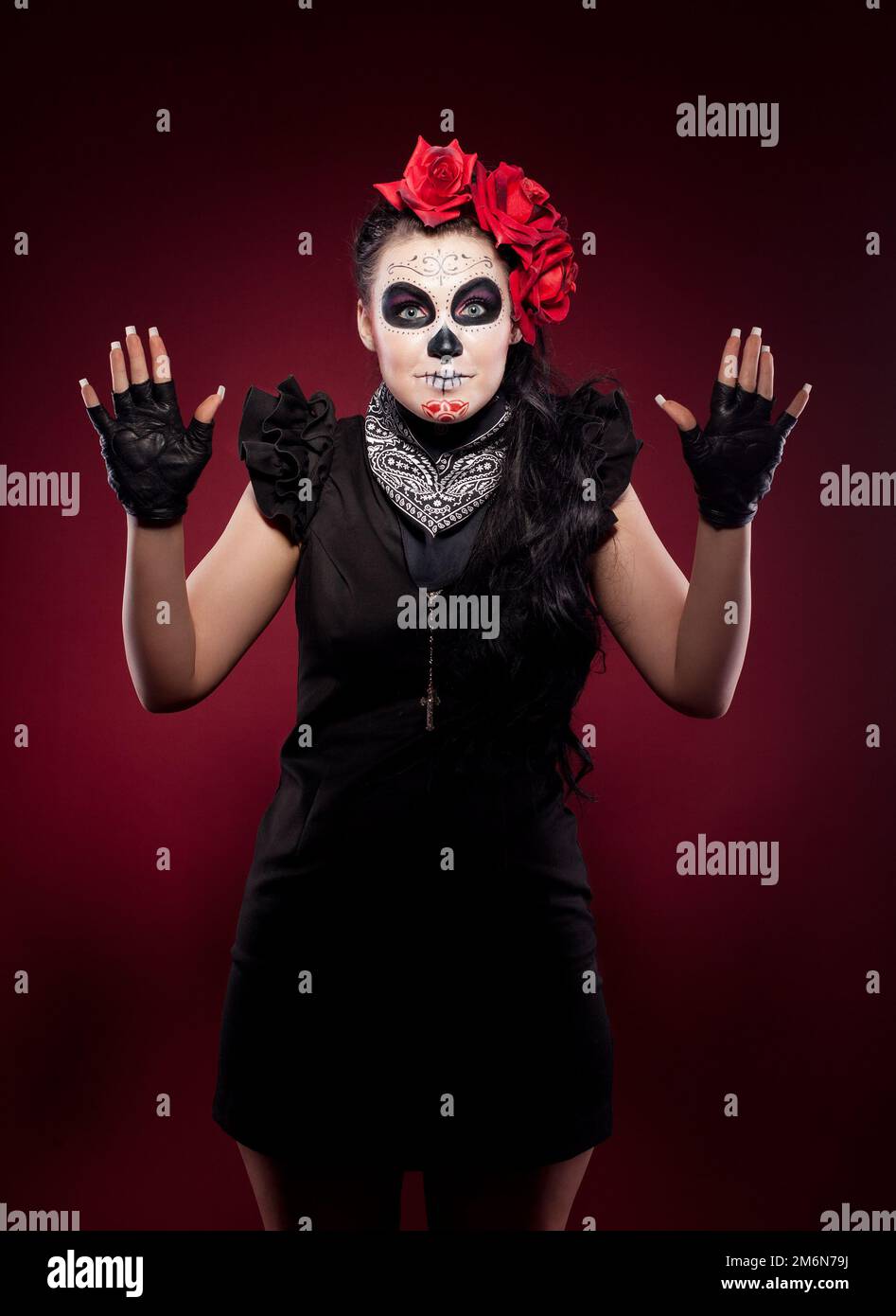 Funny woman in day of the dead mask smile on red Stock Photo