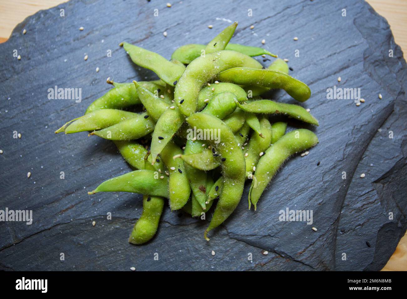 Edamame is a preparation of immature soybeans in the pod, found in