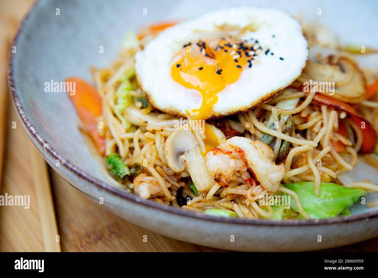 Yakisoba noddles with shrimps and egg on the top. Literally 'fried noodles', integrated into Japanese cuisine, just like ramen. Stock Photo