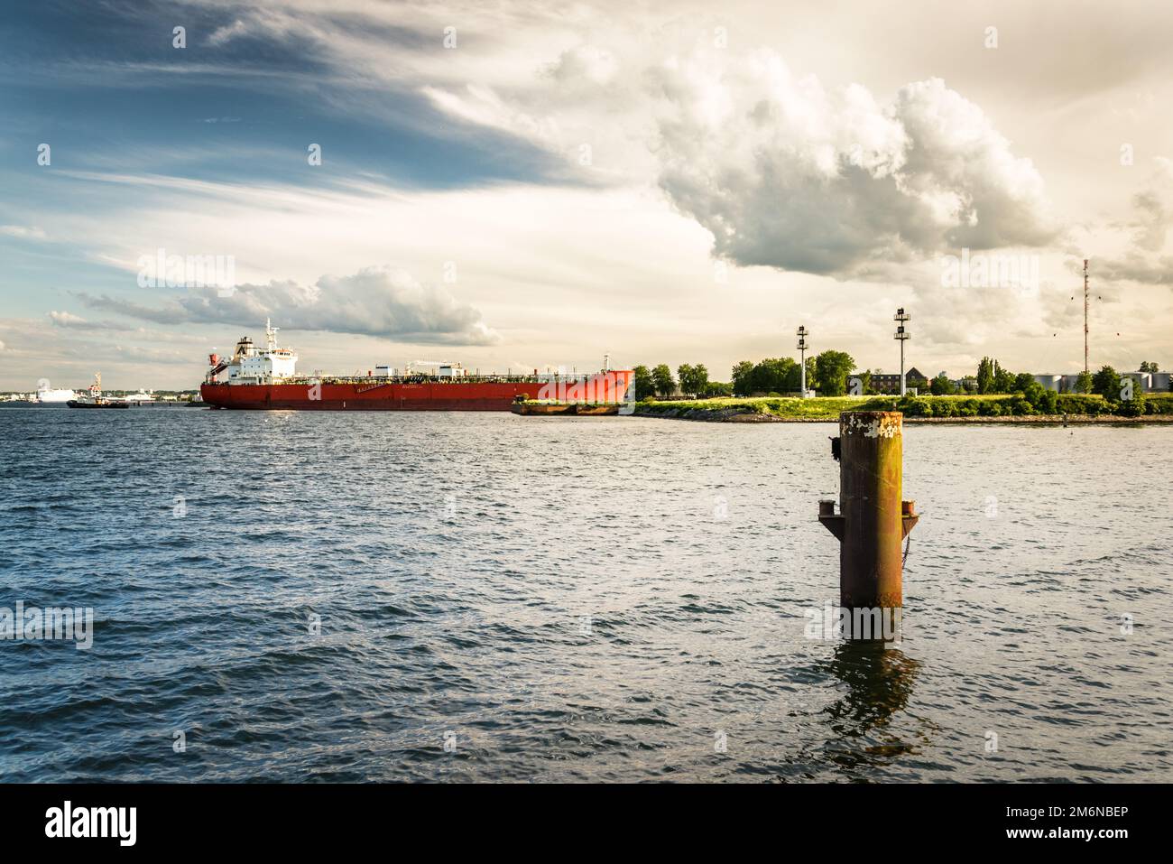 A maritime vessel is entering the Kiel Canal from the Baltic Sea. The Kiel Canal links the Baltic Sea with the North Sea Stock Photo