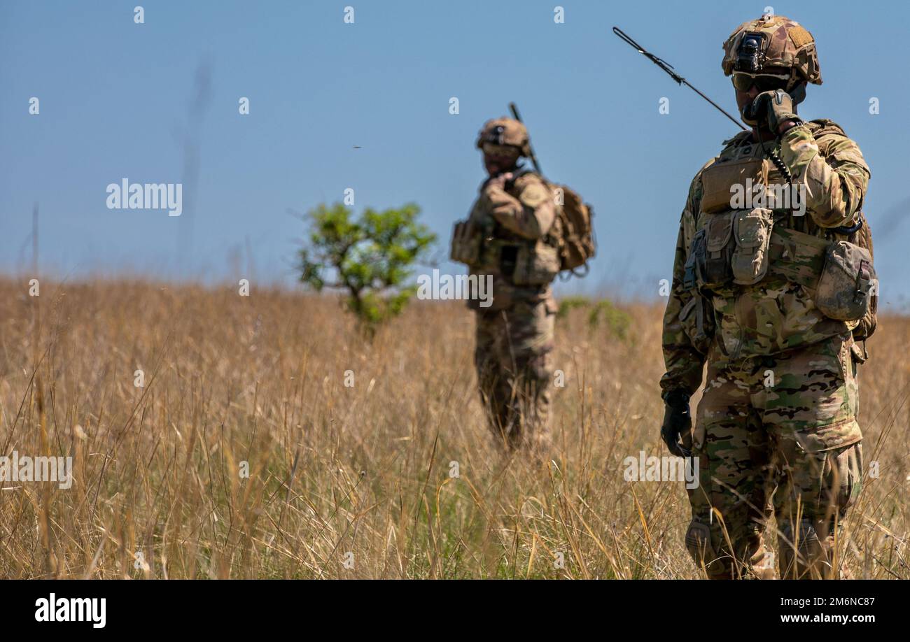U.S. Army Sgt. 1st Class Swindell White, an infantryman assigned to 2nd  Cavalry Regiment, direct troop movement using a radio during a Live Fire  Exercise in Babadag Training Area on May 2,