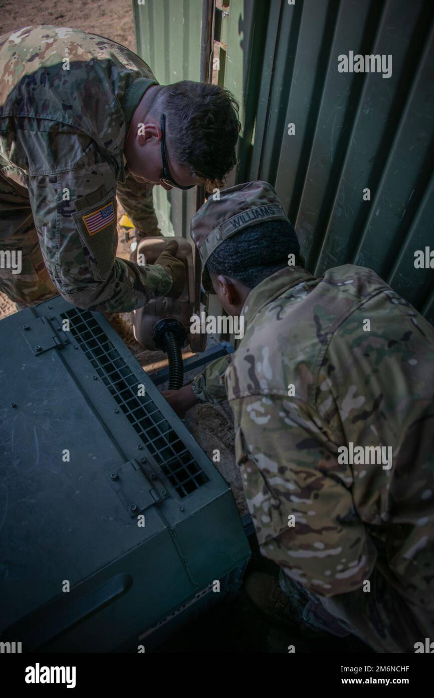 Sgt. Daniel Ivaska (left) and Spc. Macavion Williams conduct generator maintenance to keep the 510th Regional Support Group’s Tactical Operations Center near Adazi, Latvia. Starting in mid-April, Soldiers with the 510th RSG began base support operations in Estonia, Latvia and Lithuania to support multinational training events as part of DEFENDER-Europe 22. Stock Photo